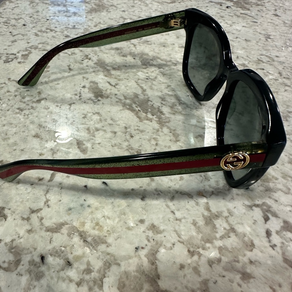 Authentic Gucci used sunglasses for sale. Green and red sides.